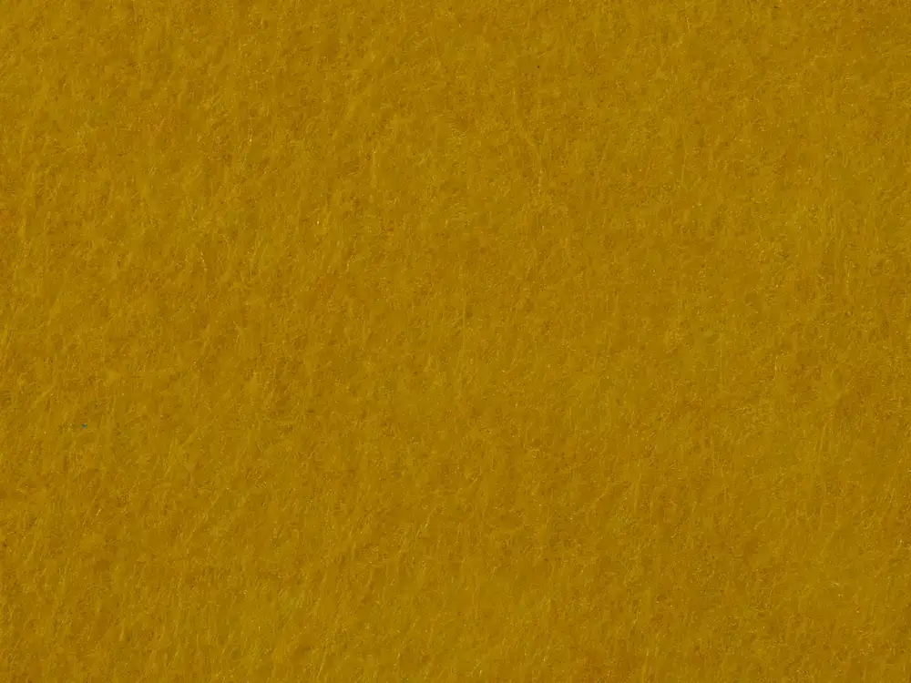 Close up texture of fine wool felt illuminated by warm studio light