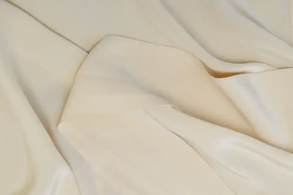 Close up view of fine silk lining and a stamped leather sweatband inside a custom hat