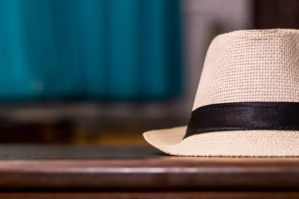 A lightweight straw panama hat resting on a studio table